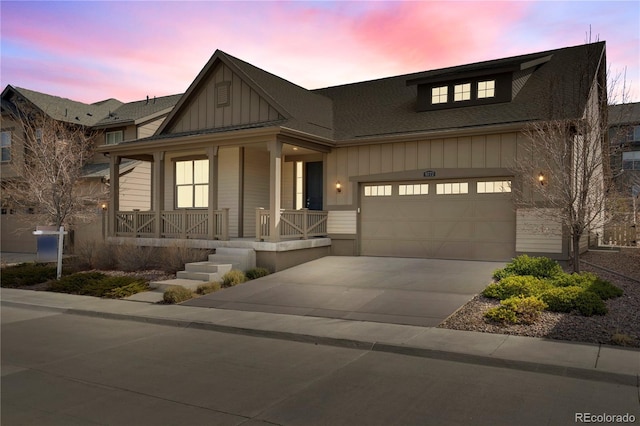 view of front facade with board and batten siding, a porch, a shingled roof, and driveway