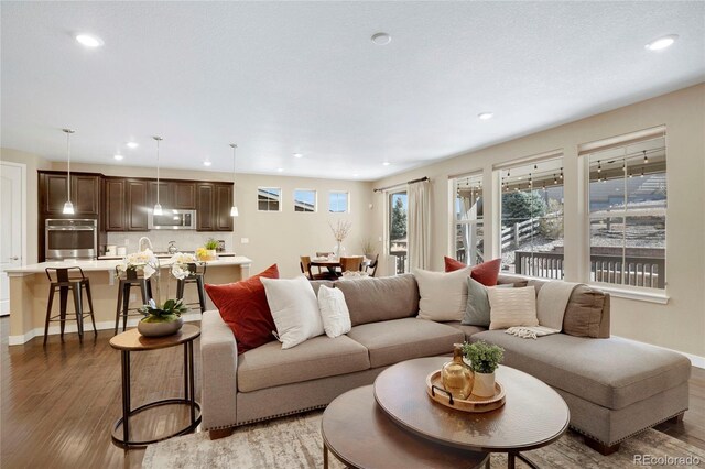 9772 Taylor River Cir, Littleton, CO 80125 - living area featuring light wood-style floors, recessed lighting, and baseboards