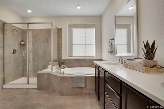 full bath featuring a bath, a shower stall, vanity, and tile patterned flooring