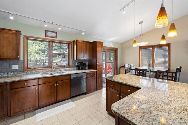 kitchen featuring vaulted ceiling, a wealth of natural light, sink, and dishwasher