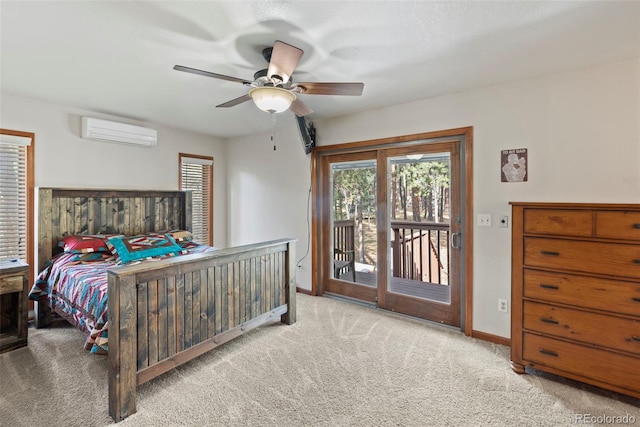 carpeted bedroom featuring a wall unit AC, ceiling fan, and access to outside