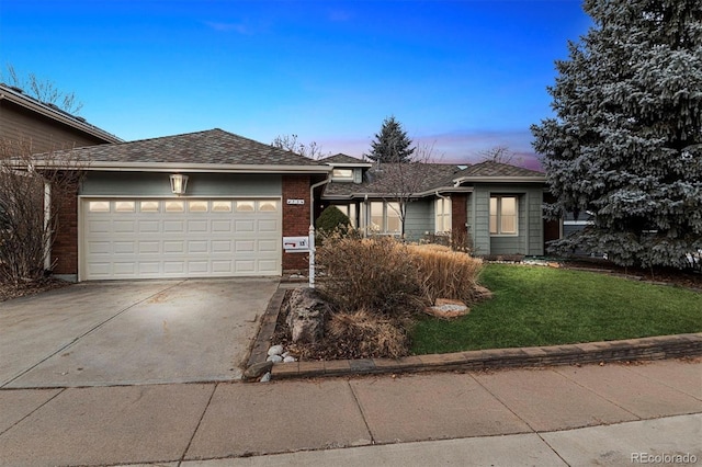 view of front of home featuring a lawn and a garage