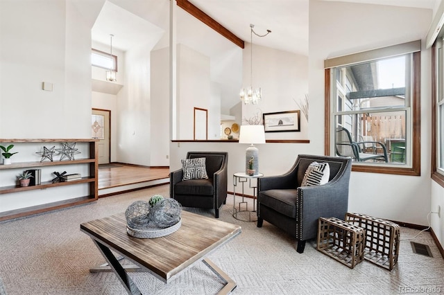 sitting room with beam ceiling, carpet floors, high vaulted ceiling, and an inviting chandelier