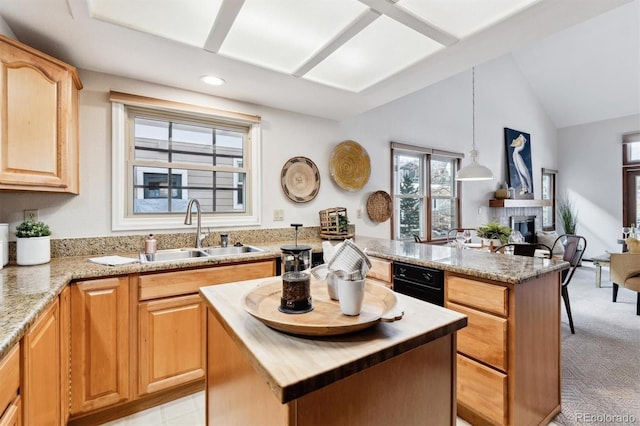 kitchen with a center island, decorative light fixtures, light colored carpet, and sink