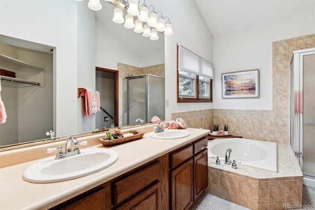 bathroom with vanity, vaulted ceiling, and shower with separate bathtub