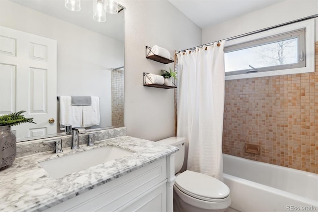 full bathroom with shower / tub combo, vanity, and toilet