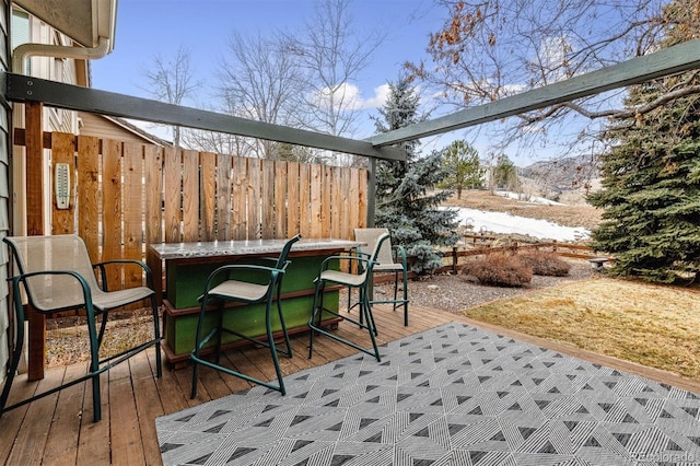 view of patio featuring exterior bar and a wooden deck