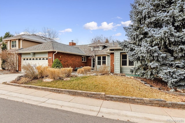 view of front of house with a front yard and a garage