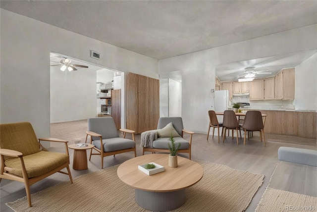 interior space with light wood-style flooring, visible vents, and a ceiling fan