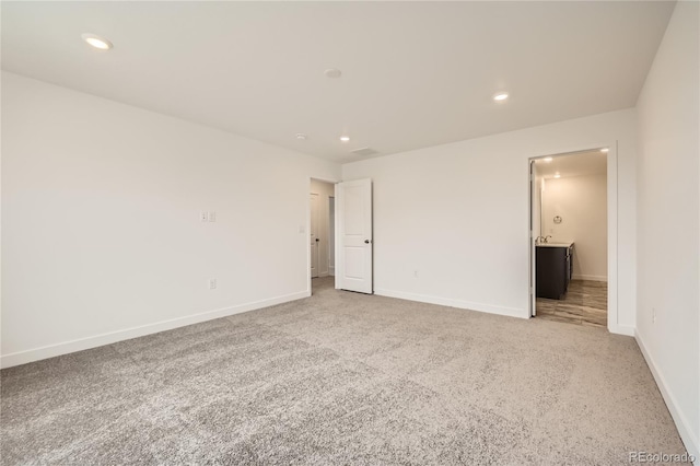 unfurnished room featuring light colored carpet