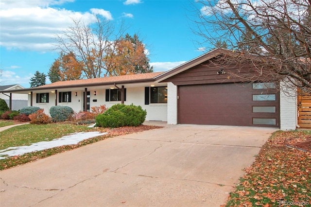 5886 S Logan St, Centennial, CO 80121 - ranch-style house with an attached garage, driveway, and brick siding