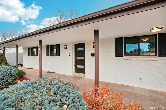 5886 S Logan St, Centennial, CO 80121 - view of exterior entry with brick siding and covered porch