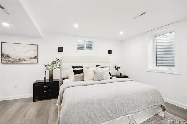 5886 S Logan St, Centennial, CO 80121 - bedroom featuring wood finished floors, recessed lighting, and multiple windows