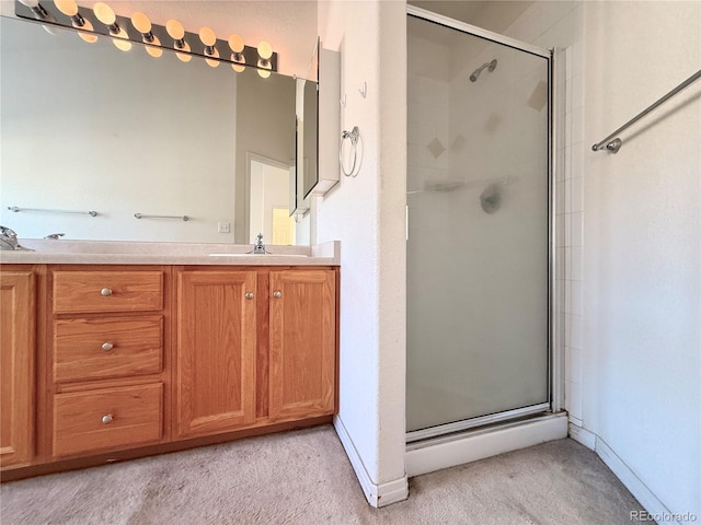 bathroom featuring vanity and a shower with door