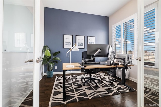 office space with baseboards, french doors, and hardwood / wood-style flooring