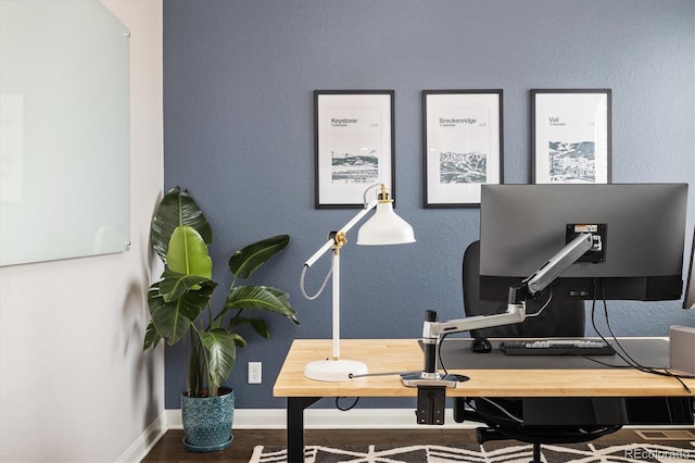 office area featuring baseboards and wood finished floors