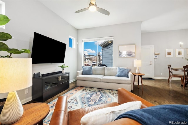 living room featuring baseboards, ceiling fan, and wood finished floors