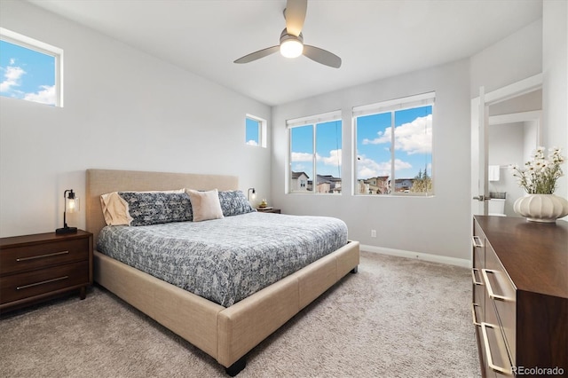 carpeted bedroom featuring baseboards and ceiling fan