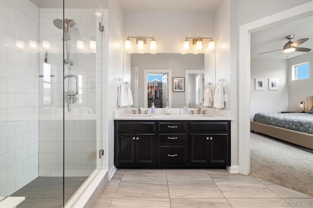 full bathroom featuring a stall shower, double vanity, a sink, and a ceiling fan