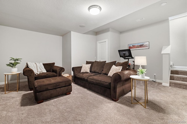 living room with carpet, baseboards, stairs, and a textured ceiling