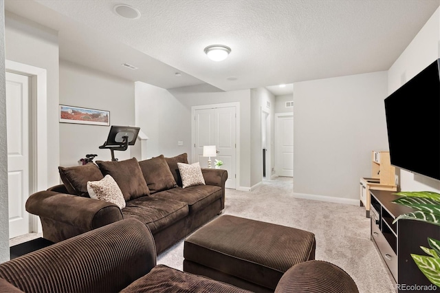 living room featuring light carpet, baseboards, visible vents, and a textured ceiling
