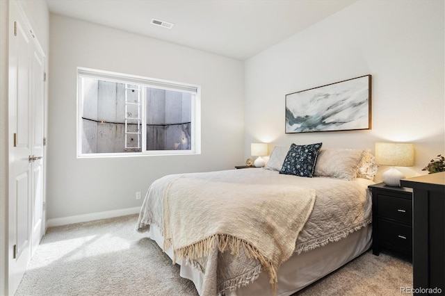 bedroom with baseboards, visible vents, and carpet flooring