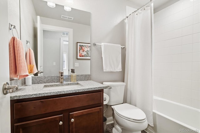 bathroom featuring visible vents, toilet, shower / tub combo, and vanity