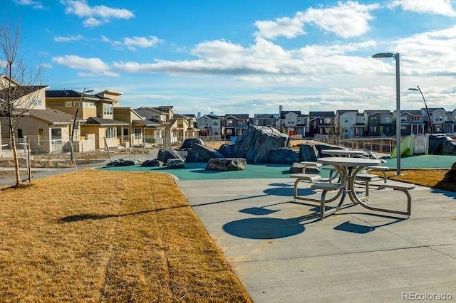 view of home's community with a residential view and a lawn
