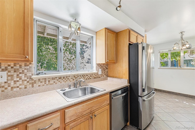 2017 Jackson St, Golden, CO 80401 - kitchen featuring stainless steel appliances, decorative backsplash, light countertops, light tile patterned flooring, and a chandelier