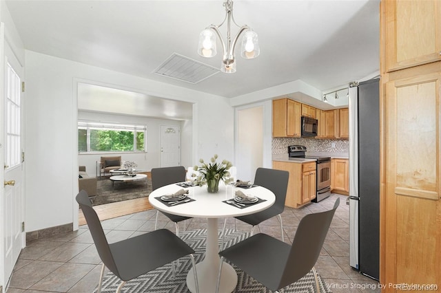2017 Jackson St, Golden, CO 80401 - dining room with light tile patterned floors and a chandelier