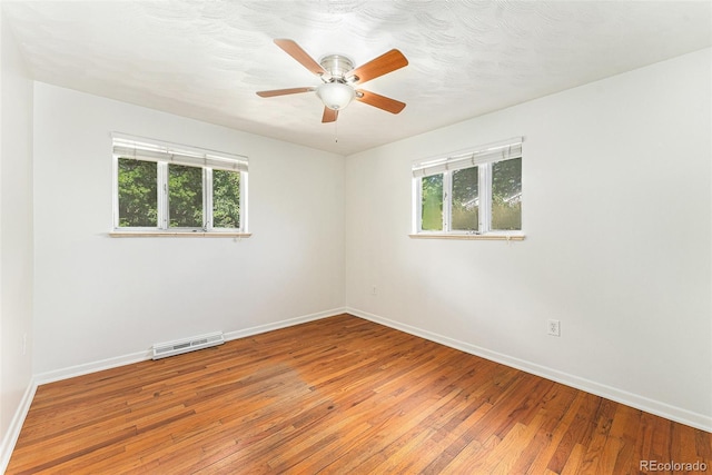 2017 Jackson St, Golden, CO 80401 - empty room with healthy amount of natural light, light wood-style floors, and a ceiling fan