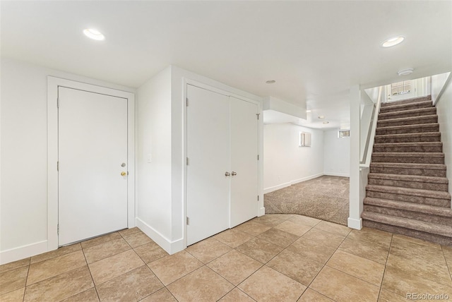 2017 Jackson St, Golden, CO 80401 - finished below grade area with stairs, recessed lighting, light tile patterned flooring, and light colored carpet