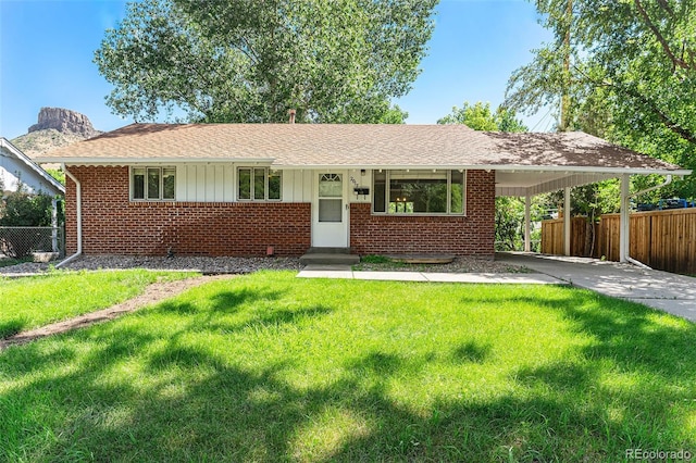 2017 Jackson St, Golden, CO 80401 - ranch-style home with brick siding, an attached carport, driveway, a shingled roof, and board and batten siding