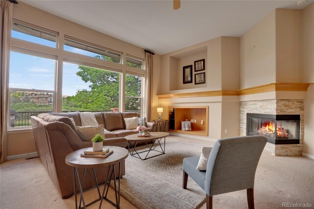 1001 Deer Clover Way, Castle Pines, CO 80108 - living area with plenty of natural light, light carpet, and a fireplace