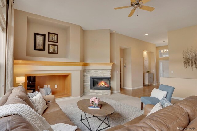 1001 Deer Clover Way, Castle Pines, CO 80108 - living area with a ceiling fan, a stone fireplace, and recessed lighting