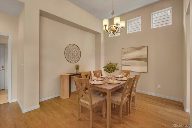 1001 Deer Clover Way, Castle Pines, CO 80108 - dining space featuring a chandelier and light wood-style flooring