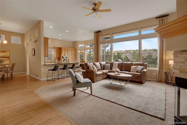 1001 Deer Clover Way, Castle Pines, CO 80108 - living room with light wood-style floors, a chandelier, ceiling fan, plenty of natural light, and recessed lighting