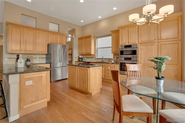 1001 Deer Clover Way, Castle Pines, CO 80108 - kitchen featuring appliances with stainless steel finishes, light brown cabinetry, light wood finished floors, backsplash, and recessed lighting
