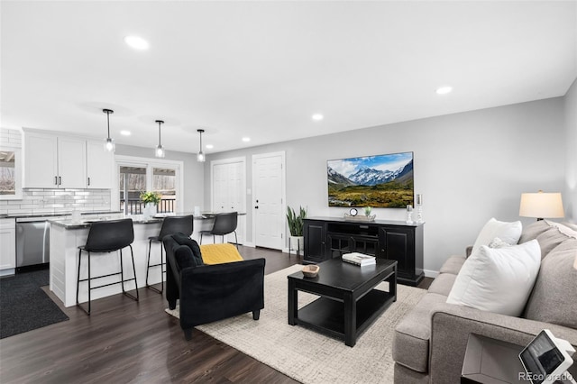 living area with dark wood-style floors and recessed lighting