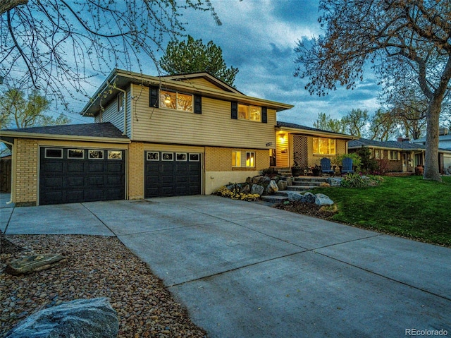 tri-level home featuring a porch, a garage, driveway, and a front lawn