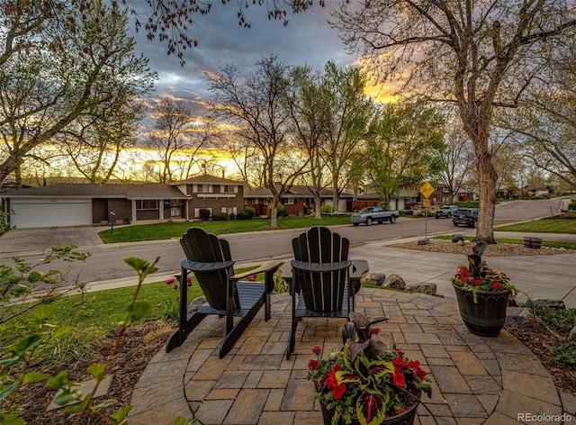 view of patio / terrace with concrete driveway and a residential view
