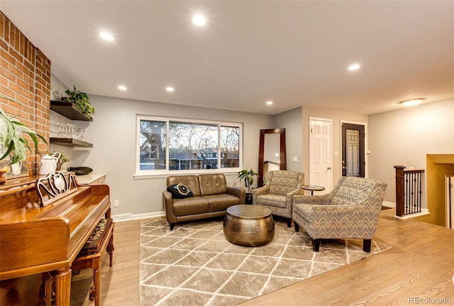 living room featuring recessed lighting, baseboards, and light wood-type flooring