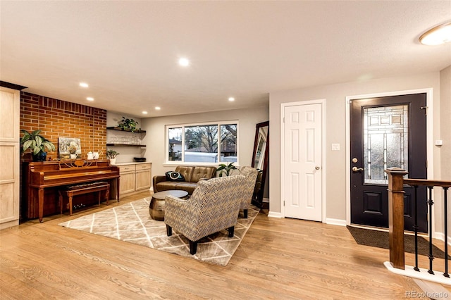 living area with baseboards, recessed lighting, and light wood-style flooring