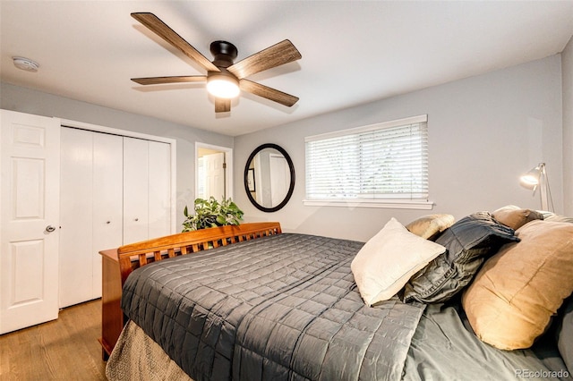 bedroom with a closet, a ceiling fan, and light wood-style floors