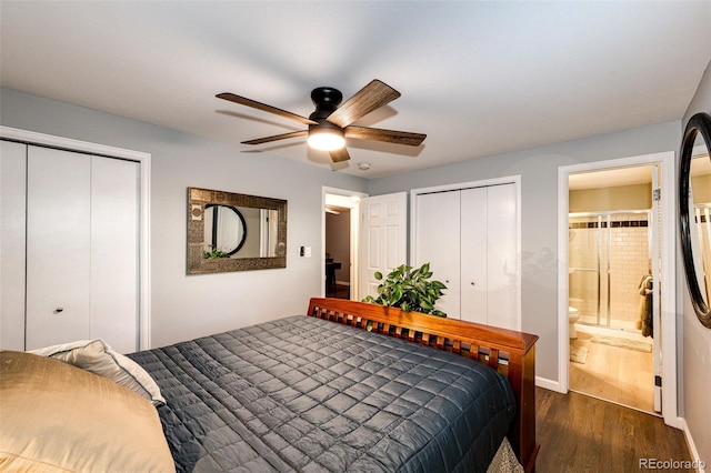 bedroom with dark wood-style flooring, ceiling fan, baseboards, and ensuite bath