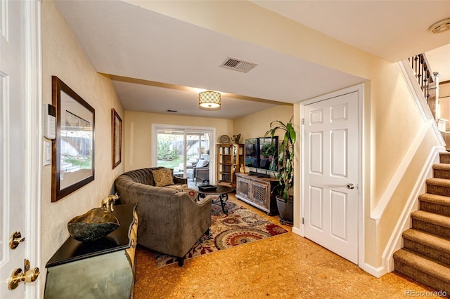 living area with visible vents and stairway