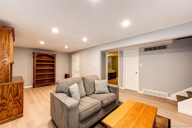 living room with baseboards, light wood-type flooring, and visible vents