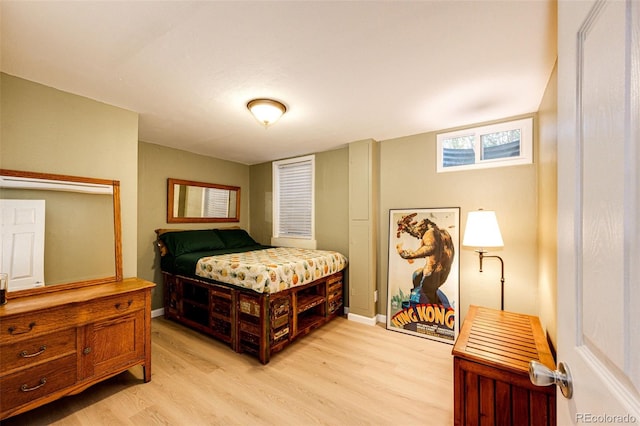 bedroom with light wood-style floors and baseboards