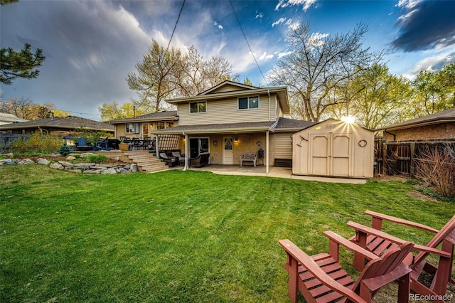 rear view of house featuring a shed, a fenced backyard, an outbuilding, a patio area, and a lawn