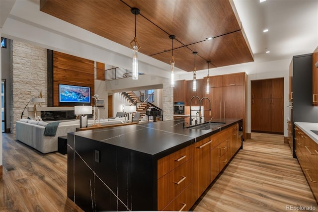 5140 S Kearney Ct, Greenwood Village, CO 80111 - kitchen with modern cabinets, a sink, light wood finished floors, brown cabinets, and wooden ceiling